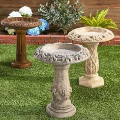 two cement pedestals sitting on top of green grass