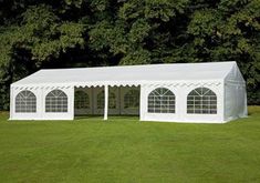 a large white tent set up in the grass