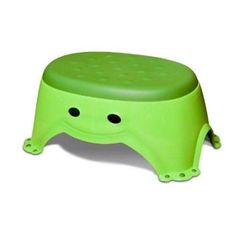 a green step stool with holes in the bottom and feet on it's sides