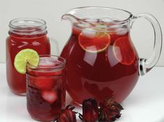 a pitcher and two glasses filled with red liquid