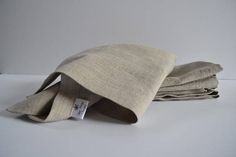 three folded linen napkins sitting on top of each other