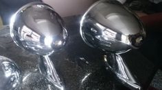 three chrome balls sitting on top of a black counter