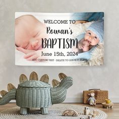 a baby's birth announcement is displayed on the wall next to a stuffed dinosaur