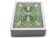 a green and white playing card sitting on top of a table