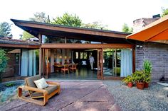 an outdoor patio with chairs, tables and umbrellas