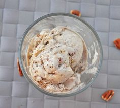 a glass bowl filled with ice cream and pecans