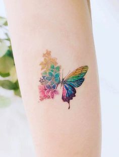 a colorful butterfly tattoo on the right thigh and lower leg, with flowers painted on it