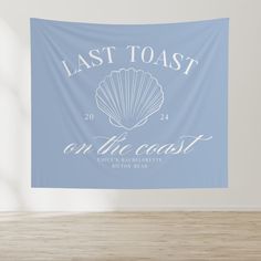 a blue wall tapestry with the words last toast and an image of a seashell