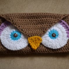 a crocheted owl headband with blue eyes