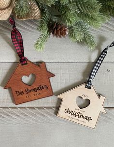 two personalized wooden christmas ornament hanging from a tree