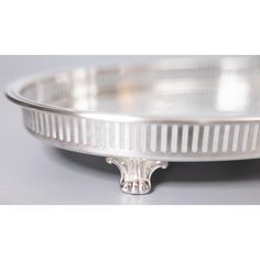 a silver plate with an ornate design on the rim