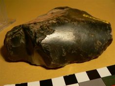 a rock sitting on top of a yellow table