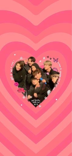 the group is posing in front of a heart