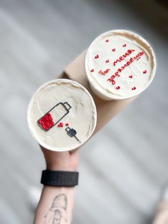 two cupcakes that have been decorated to look like they are holding wine glasses