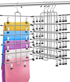 a rack with several different colored bags hanging from it