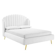 a white bed with gold legs and a headboard on top of it, in front of a white background