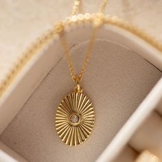 Our Gold Filled Oval Sun Necklace is an accessory that shines its way into your heart! With a 14k gold-filled hammered coin pendant, a beaded chain and a gorgeous round circumference of 16.2mm, this necklace adapts to you easily with its adjustable length. And don't worry about it getting wet or tarnished, because it's waterproof, hypoallergenic and resistant to corrosion - you can wear it fearlessly! - 14k gold-filled- Circle circumference: 16.2 mm. Pendant: 19mm (height) x 14mm (width)- Adjust Getting Wet, Sun Necklace, Coin Pendant, Beaded Chain, Free Giveaway, Chain Lengths, Chain Length, Don't Worry, Gold Filled