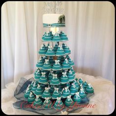 a wedding cake made to look like a christmas tree with cupcakes on top