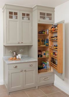 an open pantry in the corner of a room