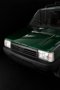 a green van parked in a dark room