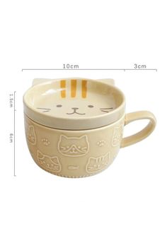 a small cup with a cat design on it