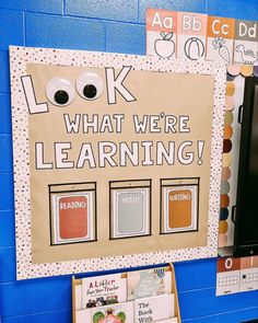 a bulletin board that says look what we're learning with pictures and words on it