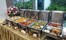 a buffet table filled with lots of different types of food