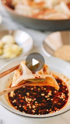 a plate with some food on it and chopsticks sticking out of the top