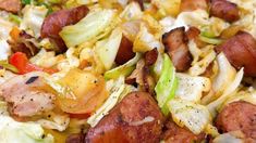 this is a close up view of some sausages, cabbage and tomatoes on a plate