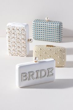 Bring your bridal celebrations wherever you go with Shiraleah's "Bride" Pearl Minaudiere. This classic white purse features the word "Bride" embroidered in chic faux pearls with a faux pearl top closure. You can carry it like a clutch or use the detachable cross-body chain for some extra versatility in your style. Pair with other items from Shiraleah's Hitched collection to complete your look! Features a detachable cross-body chain and a magnetic frame closure Shiraleah is a trend-driven lifesty White Pearl Clutch For Events, White Pearl Clutch Gift, White Clutch With Pearl Handle As Gift, Event White Clutch With Pearl Handle, White Clutch With Pearl Handle For Events, White Rectangular Clutch With Pearl Embroidery, White Pearl Embroidered Clutch For Formal Occasions, White Pearl Embroidery Clutch For Formal Occasions, White Clutch With Pearl Embroidery As Gift