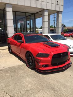 a red car parked in front of a building