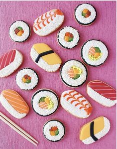 sushi cookies on a pink surface with chopsticks