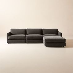 a black couch sitting on top of a white floor