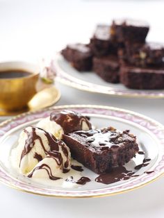 two plates with brownies and ice cream on them