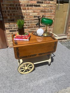 a small wooden cart with books on it