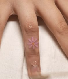 a woman's hand with a pink flower on it