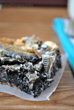 two pieces of cake sitting on top of a wooden table