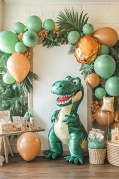 an inflatable dinosaur sits next to balloons and streamers for a birthday party