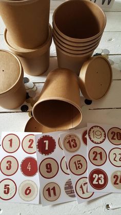 several brown cups and numbers are on the table next to each other with stickers