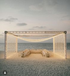 an outdoor wedding set up on the beach