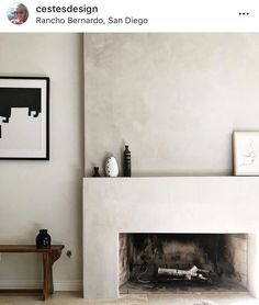 a living room with a fire place and pictures on the wall