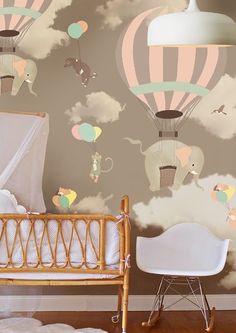 a baby's room with hot air balloons in the sky