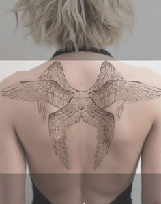 the back of a woman's neck with two birds on it