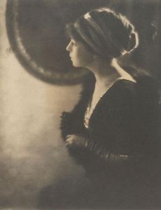 an old black and white photo of a woman