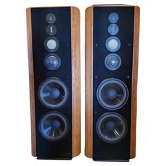 two wooden speakers sitting next to each other