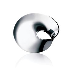 a silver object is shown on a white surface with its reflection in the glass and it's circular shape