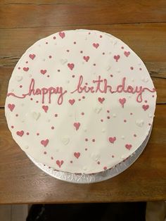 a birthday cake with hearts and the words happy birthday written on it