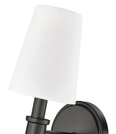 a black wall light with a white shade on the top and bottom half of it