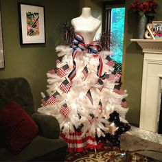 a christmas tree decorated with red, white and blue ribbons