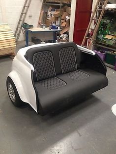 a white and black couch sitting inside of a garage